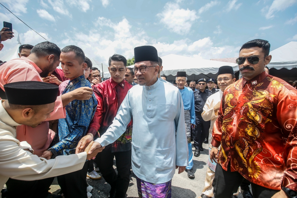 Prime Minister Datuk Seri Anwar Ibrahim (centre) arrives at the Bandar Utama Batang Kali Mosque for the Hari Raya open house and Friday prayers in Batang Kali, Hulu Selangor April 12, 2024. — Picture by Hari Anggara